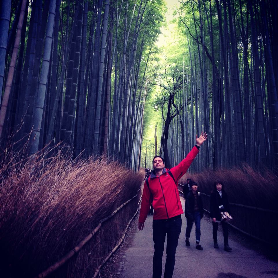 Vlad Sterngold reaching up in the Arashiyama bamboo grove, Kyoto
